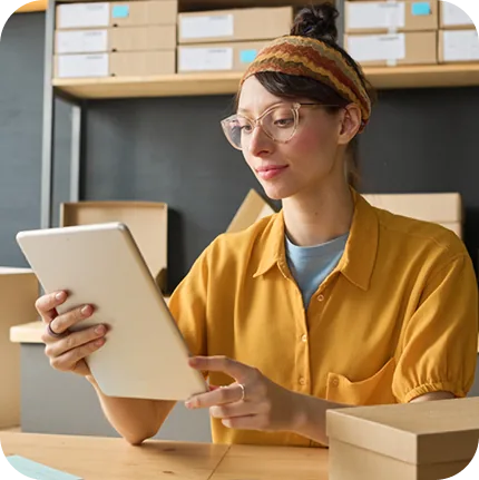 Teammate checks inventory on a tablet before assembling sets.